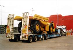 Low Loader vehicle with yellow truck