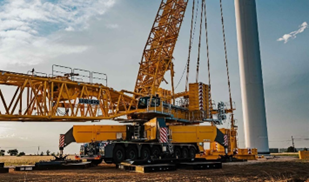 Upright yellow crane with two booms extended