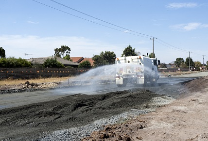 Water truck spraying road surface