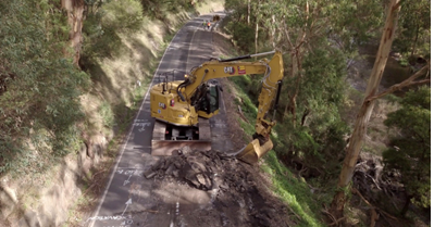Digger excavating on a road