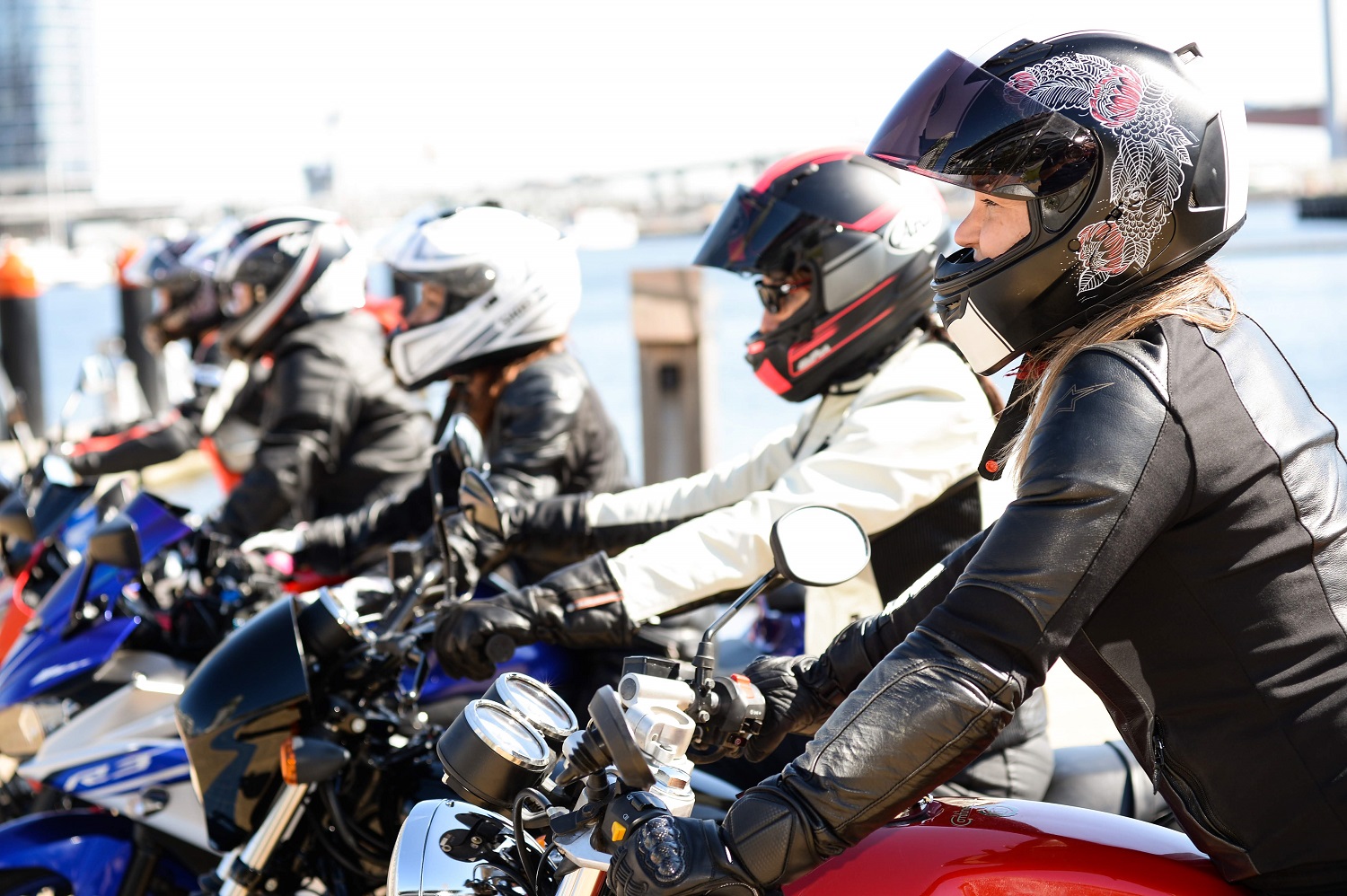 Five motorcyclist sitting on their bikes side by side