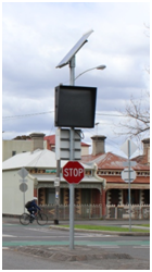 Image of a bicycle activated warning sign post on the roadside