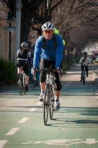 Man riding bike on a shared path