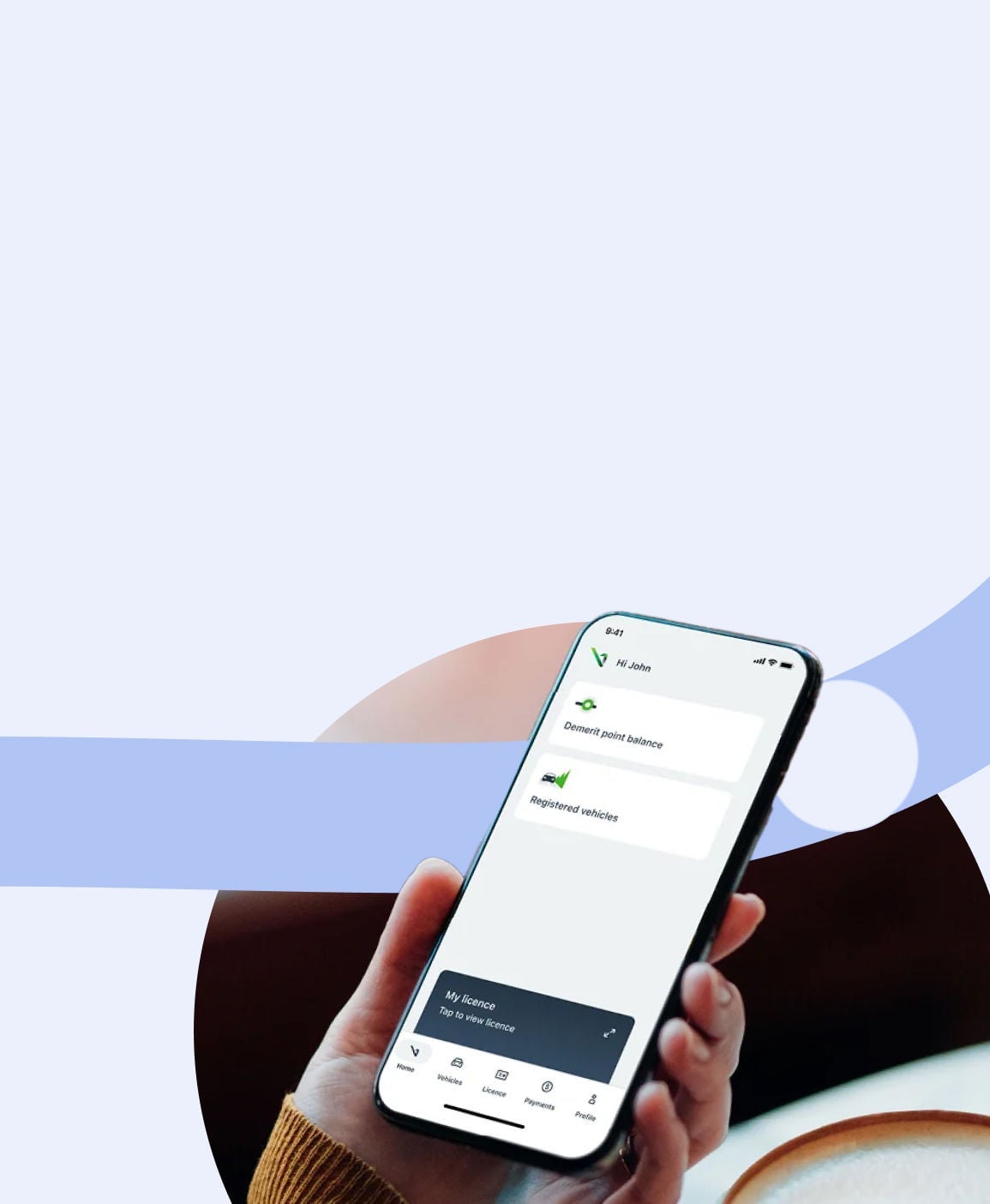 A close-up of a hand holding a smartphone displaying an app interface. Download the myVicRoads app.